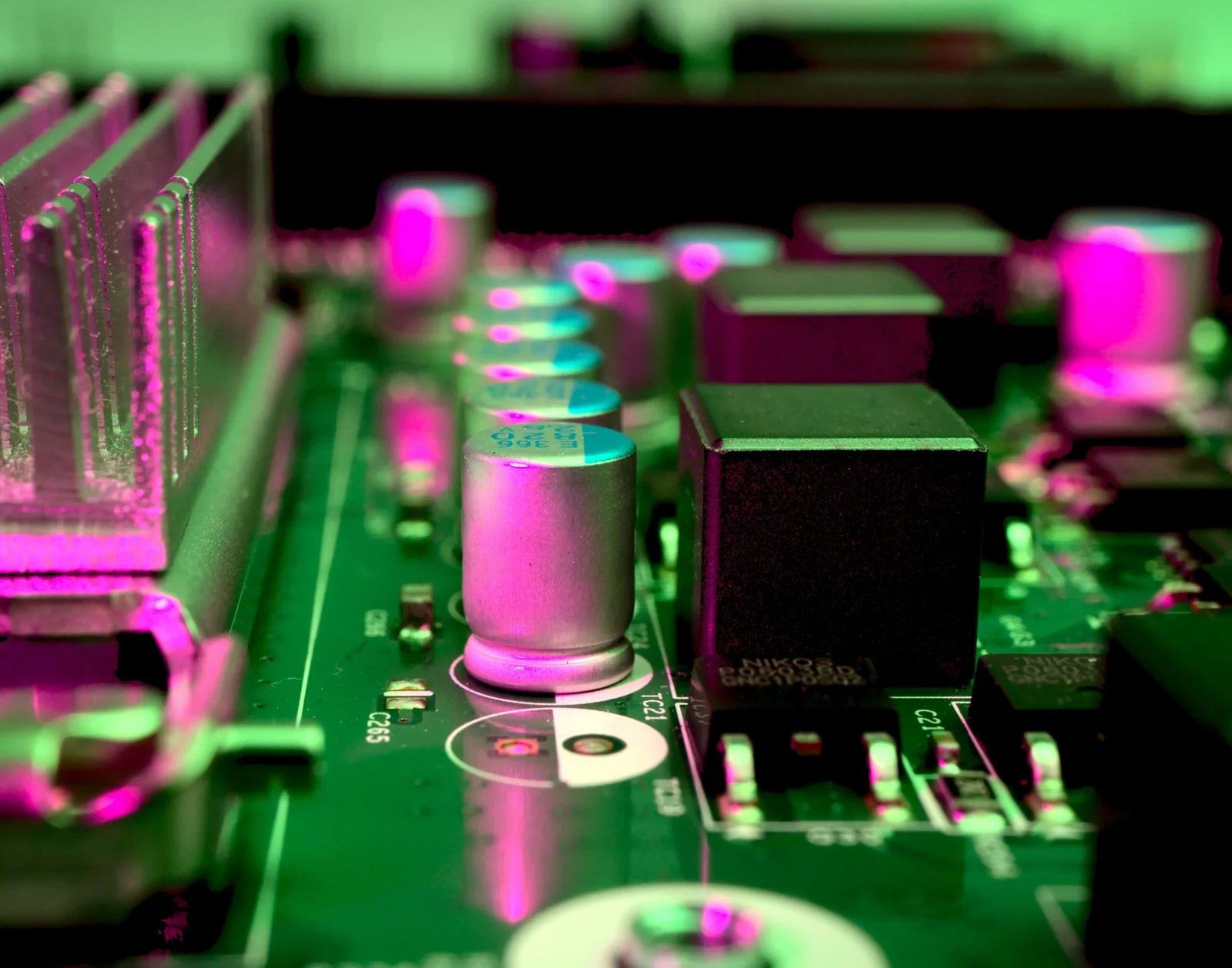a close up of a computer motherboard with pink lights
